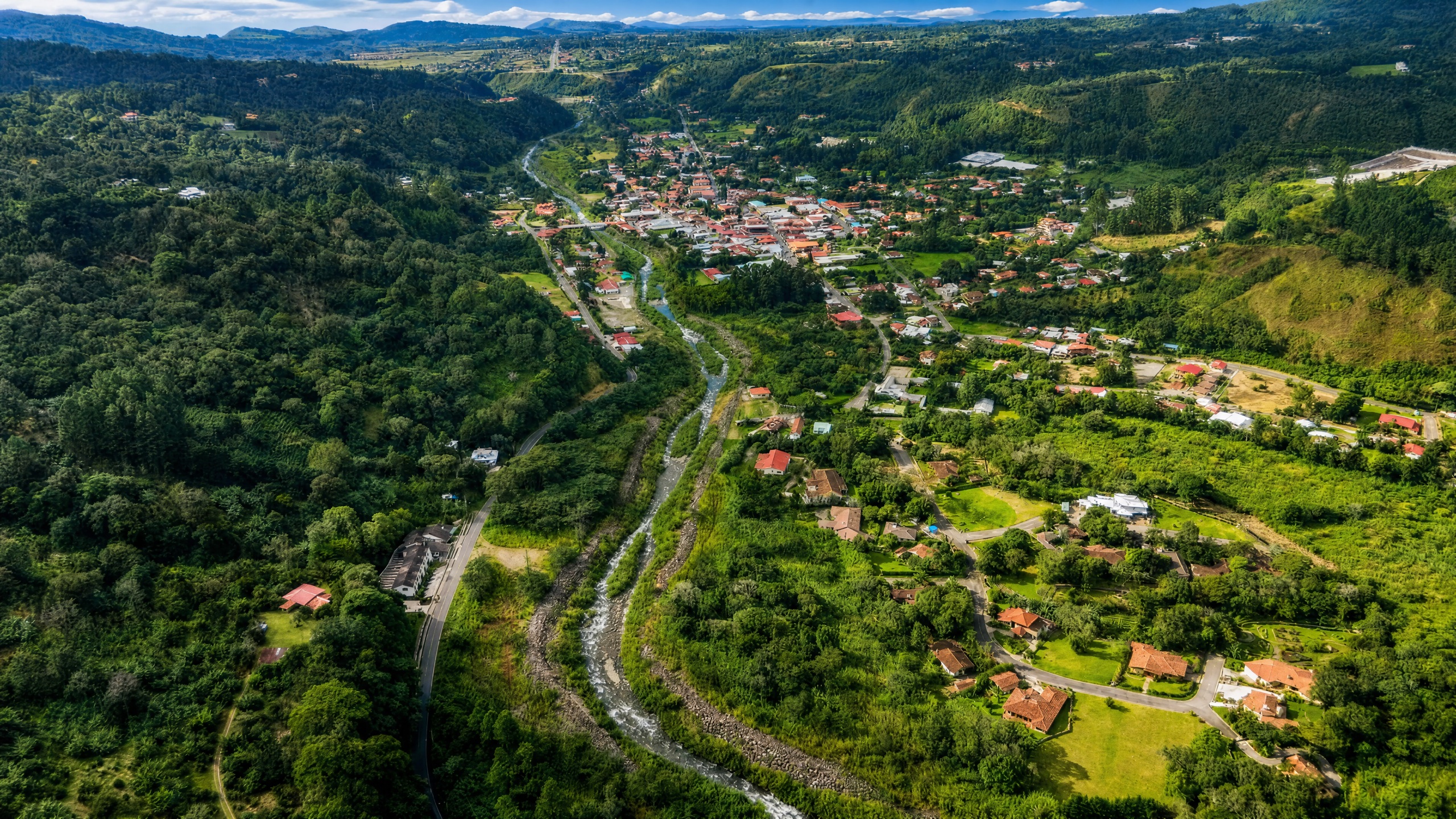 Boquete mountain town in Panama, lush green coffee farm hillsides, misty cloud forest and Volcan Baru in the distance.