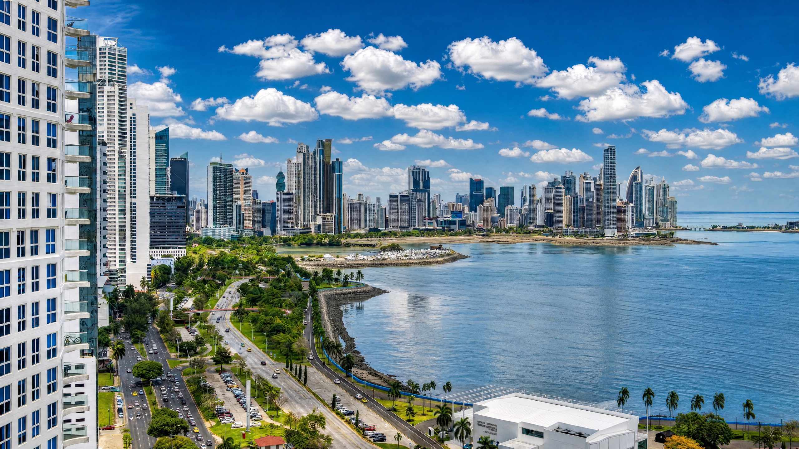Aerial view of Punta Pacifica peninsula in Panama City at golden hour, modern luxury high-rise condo towers facing the Pacific Ocean.