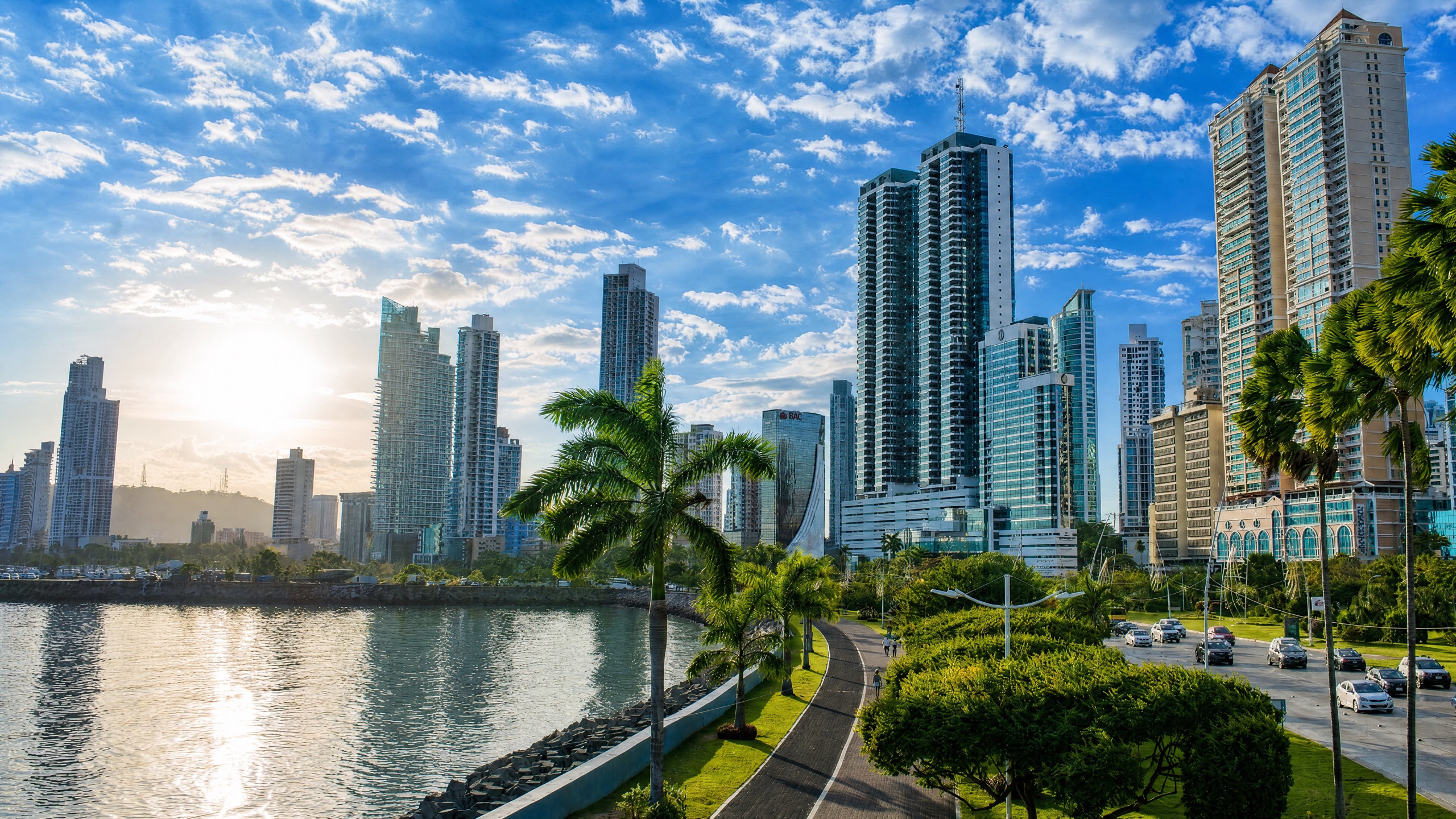 Bella Vista and the Cinta Costera waterfront in Panama City, mid-rise residential apartment towers along the Avenida Balboa coastal beltway of Panama Bay at golden hour.